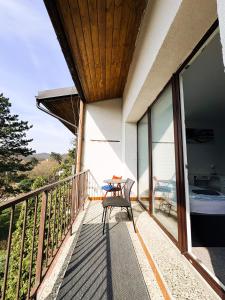 a balcony of a house with a table and chairs at ROOMS Vystaviste BVV in Brno