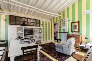 a living room with green and white striped walls at Le Vetrate sul Lago Lake Como Amazing View in Nesso