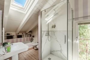 a bathroom with a shower and a sink at Le Vetrate sul Lago Lake Como Amazing View in Nesso +79 photos