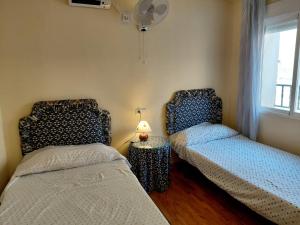 a bedroom with two beds and a window at Alojamiento Rural - El Rocin in Elche de la Sierra