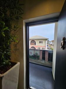 a window in a room with a view of a building at Less2More Luxury Suites in Agege