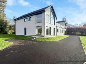 a large white house with a driveway at Grey Rocks House in Kippford