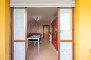 a hallway with a table and a dining room at LT Dimora Brianza in Bovísio-Masciago Milanese +3 photos