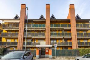 a building with cars parked in front of it at LT Dimora Brianza in Bovísio-Masciago Milanese
