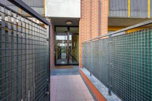 an empty hallway of a building with a gate at LT Dimora Brianza in Bovísio-Masciago Milanese