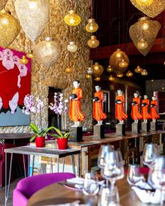 a restaurant with a table with figurines on display at Hôtel de Castigno - Wine Hotel & Resort in Assignan
