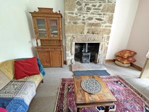a living room with a couch and a fireplace at Juniper Cottage in Buckie