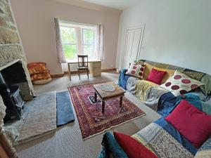 a living room with a couch and a fireplace at Juniper Cottage in Buckie