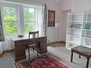 a room with a desk and a chair and a window at Juniper Cottage in Buckie +17 photos