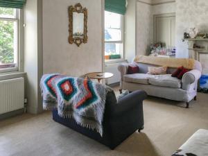 a living room with a couch and a chair at Campbells Stables in Berwick-Upon-Tweed
