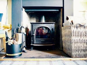a living room with a wood stove in a fireplace at Aldersyde in Tighnabruaich