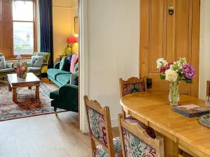 a living room with a table and a couch at Aldersyde in Tighnabruaich
