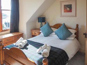 a bedroom with a bed with towels on it at Aldersyde in Tighnabruaich +8 photos