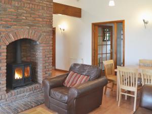 a living room with a couch and a brick fireplace at Inzievar in Oakley