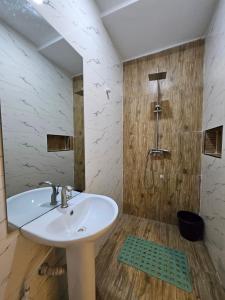 a bathroom with a sink and a shower at Less2More Luxury Suites in Agege +47 photos