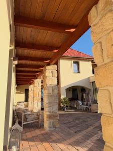 a patio with a wooden pergola at Hotel Garni Klaret in Valtice