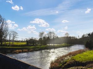 a river with a bridge in the foreground at Mabels Stable in Clitheroe