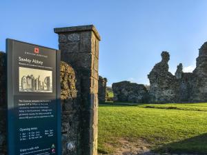 a sign with a castle in the background at Mabels Stable in Clitheroe
