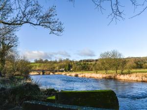 a river with a bridge in the background at Mabels Stable in Clitheroe +11 photos