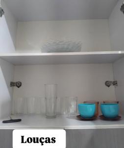 two bowls sitting on a shelf in a kitchen at Ap do Edney Águas de Lindoia in Águas de Lindoia +6 photos