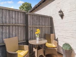 a patio with a table and chairs and a fence at Coachmans Cottage - Uk50418 in Bisterne +11 photos