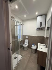 a bathroom with a shower and a toilet and a sink at Apartment for 4 in Cairo Montenotte