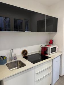 a kitchen with a sink and a microwave at Apartment for 4 in Cairo Montenotte