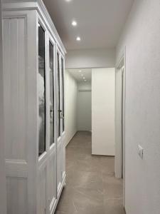 a hallway with white walls and a room with a door at Apartment for 4 in Cairo Montenotte +1 photo