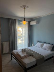 a bedroom with a bed with a blue wall at Peramos Luxury 2 in Nea Peramos