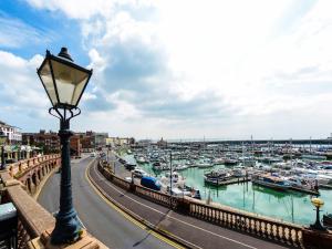 a street light next to a harbor with boats at Newington House in Ramsgate