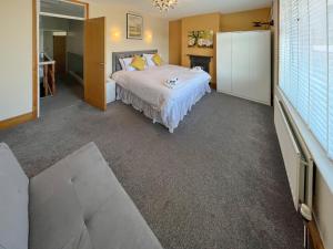 a large bedroom with a bed and a couch at Newington House in Ramsgate +7 photos