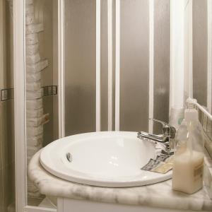a white sink in a bathroom with a mirror at APARTAMENTOS MARIAJE in Barro de Llanes +36 photos