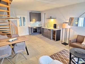 a kitchen and living room with a table and chairs at Ferienhaus Villa Seeblick - ABC223 in Bad Kleinen +17 photos