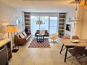 a living room with a couch and a table at Ferienhaus Villa Seeblick - ABC223 in Bad Kleinen