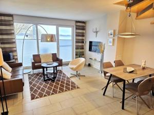 a living room with a couch and a table at Ferienhaus Villa Seeblick - ABC223 in Bad Kleinen