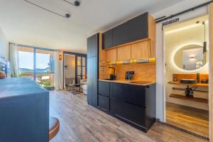 a kitchen with black cabinets and a counter top at SOL Y LUNA 11 Apartment in Sardinia close to the beach and to Olbia airport in Olbia