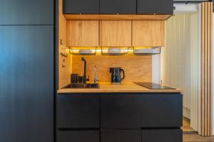 a kitchen with a sink and a counter top at SOL Y LUNA 11 Apartment in Sardinia close to the beach and to Olbia airport in Olbia +60 photos