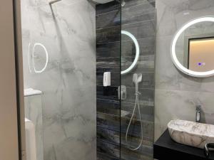 a bathroom with a sink and a mirror at HOTEL NEST in Bijeljina +54 photos