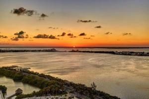 a sunset over a body of water with a beach at Royalton CHIC Cancun, An Autograph Collection All-Inclusive Resort - Adults Only in Cancún +225 photos