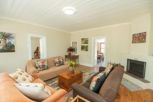 a living room with a couch and a fireplace at Deer Cottage in Kirkwood