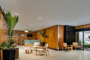 a lobby with chairs and tables in a building at Othon Palace Copacabana Rio in Rio de Janeiro +129 photos