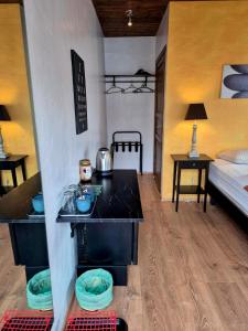 a room with a bed and a room with a kitchen at Guestroom with a mountain view in Laugarvatn