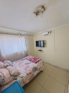 a small bedroom with a bed and a window at Le Maire Gust Lodge in Johannesburg