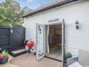 an open door of a white building with a garage at Shire Cottage - Uk50416 in Bisterne