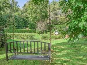 a wooden swing in a park with a yard at Shire Cottage - Uk50416 in Bisterne