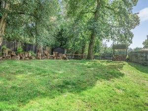 a yard with a fence and trees and a gazebo at Shire Cottage - Uk50416 in Bisterne +11 photos