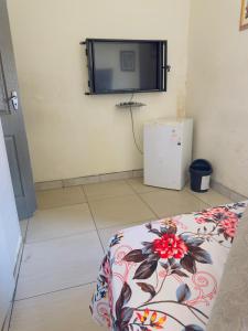 a room with a flat screen tv on the wall at Le Maire Gust Lodge in Johannesburg +1 photo