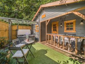 a small patio with a table and chairs on a deck at The Lodge - Uk50409 in Bisterne