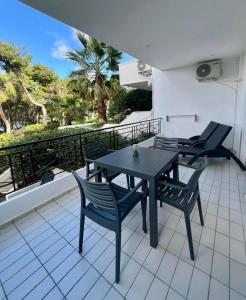 a black table and chairs sitting on a balcony at Sounio Golden View Villas in Sounio