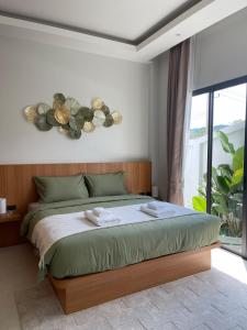 a bedroom with a bed and a large window at Vela Villa Aonang in Ban Chong Phli +57 photos